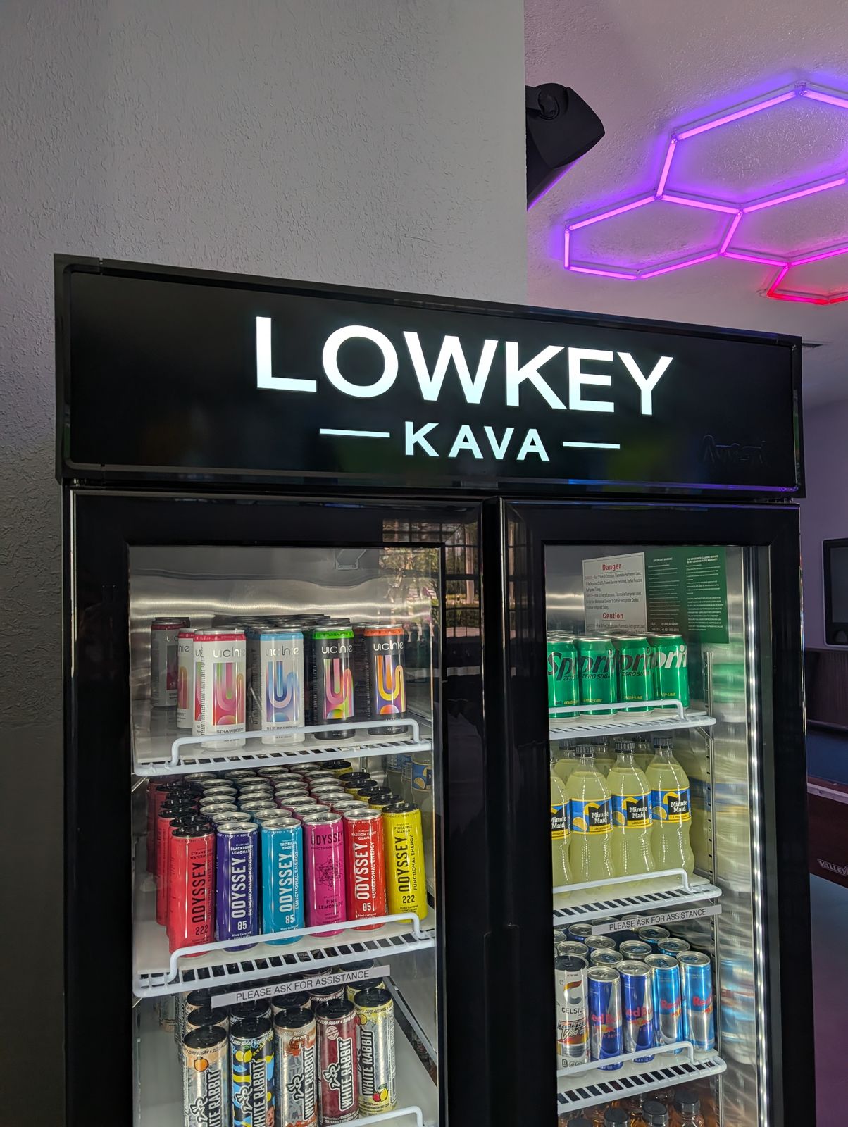 Cold drink selection fridge at Lowkey Kava featuring premium kava and kratom drinks